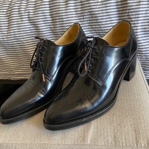 The office of Angela Scott black heeled Oxfords boots